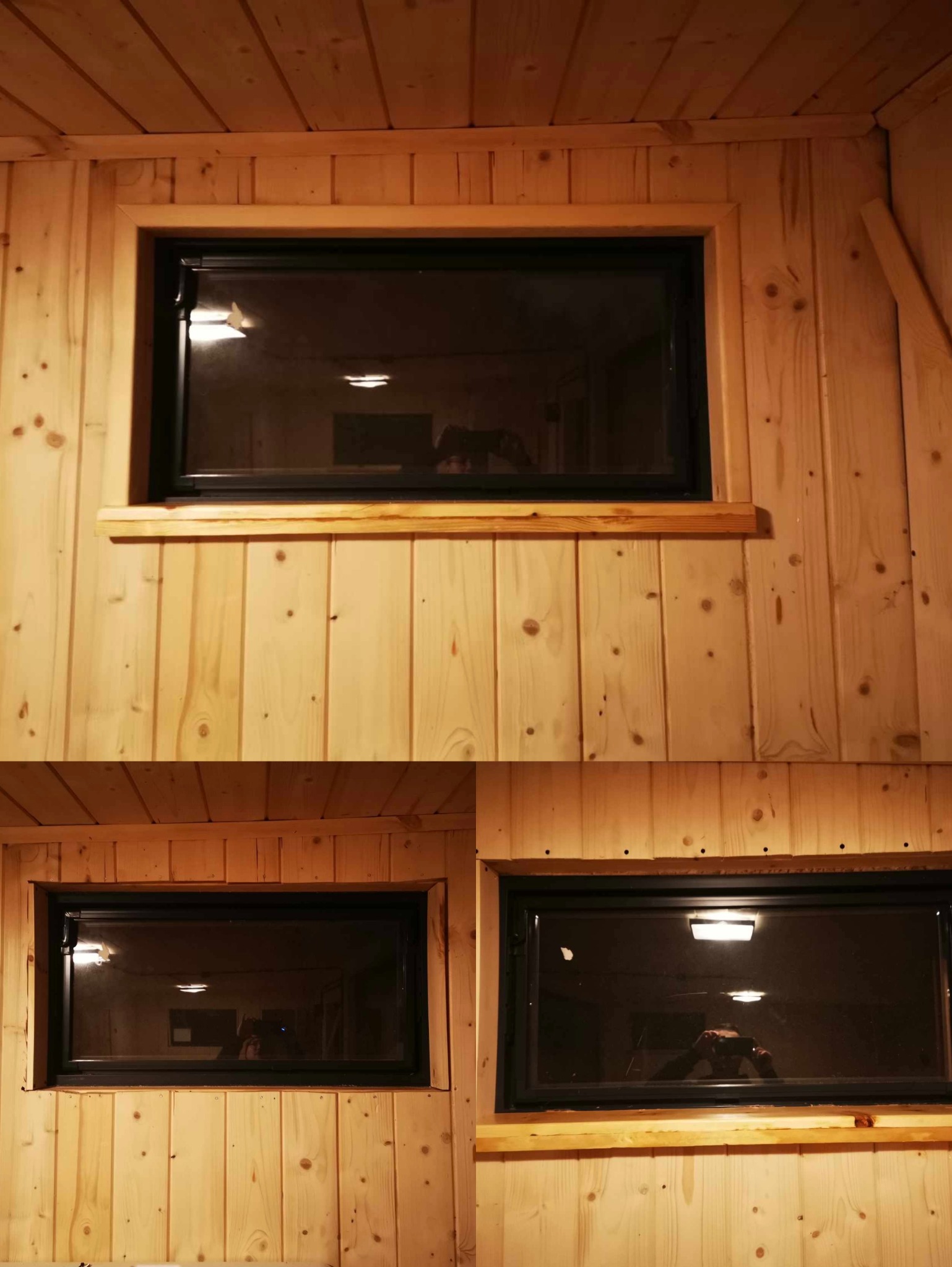 Wnętrze wykończone boazerią z widocznymi dwoma oknami z czarnymi ramami; w szybach okiennych odbija się oświetlenie i sylwetka osoby robiącej zdjęcie.