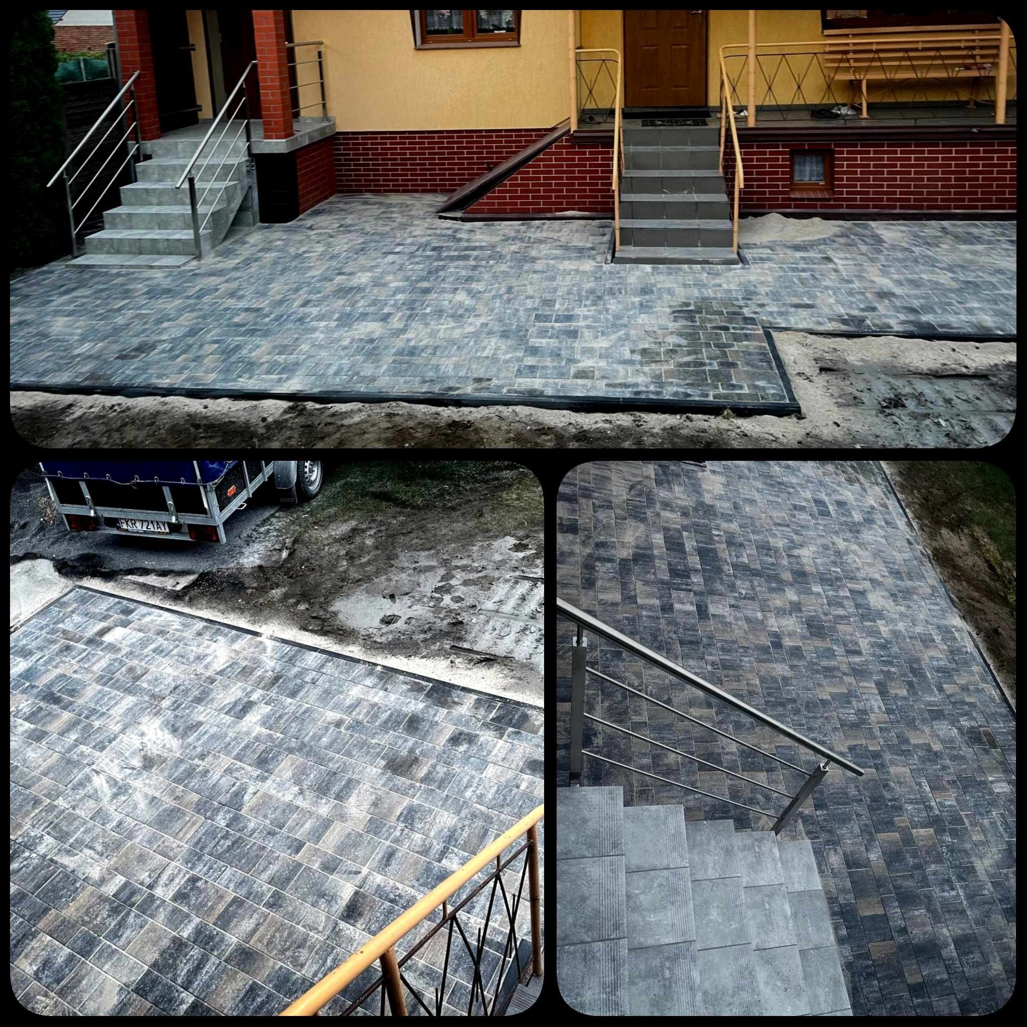 Ułożona kostka brukowa w odcieniach szarości i czerni przed domem, widoczne schody z metalową balustradą, częściowo podsypana piaskiem, z przyczepką samochodową w tle.