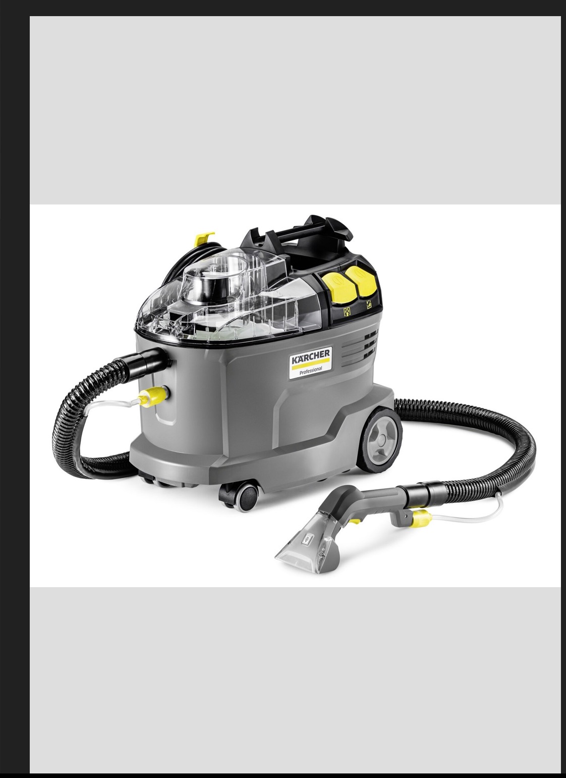 Profesjonalny odkurzacz piorący Kärcher z przezroczystym zbiornikiem, wężem i dyszą do tapicerki na białym tle. Szary korpus z żółtymi akcentami i logo.