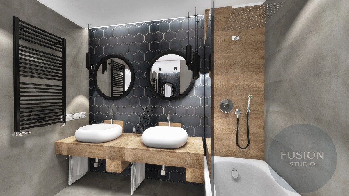 Nowoczesna łazienka z dwoma umywalkami nablatowymi o owalnym kształcie, drewnianym blatem, heksagonalnymi płytkami w odcieniach szarości oraz okrągłymi lustrami z czarnymi oprawami i wiszącymi...