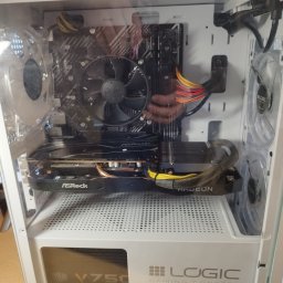 BartekDera.pl - Usługi Informatyczne i Edukacja mgr inż. Bartłomiej Dera - Wnętrze białej obudowy komputera stacjonarnego z widoczną kartą graficzną ASRock Radeon, płytą główną oraz zasilaczem Cooler Master V750, podświetlane wentylatory Logic Gaming Concept.