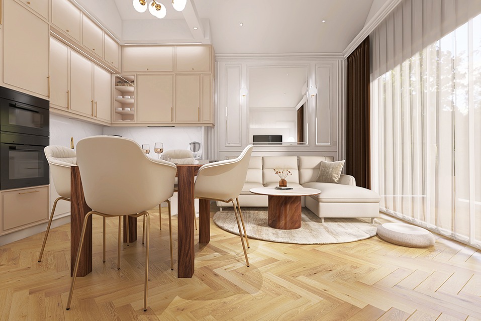 Jasne, przestronne wnętrze z aneksem kuchennym, jadalnią i strefą wypoczynkową. Widoczny stół z czterema krzesłami, sofa z poduszkami, okrągły stolik kawowy i dywan. Podłoga wyłożona parkietem...