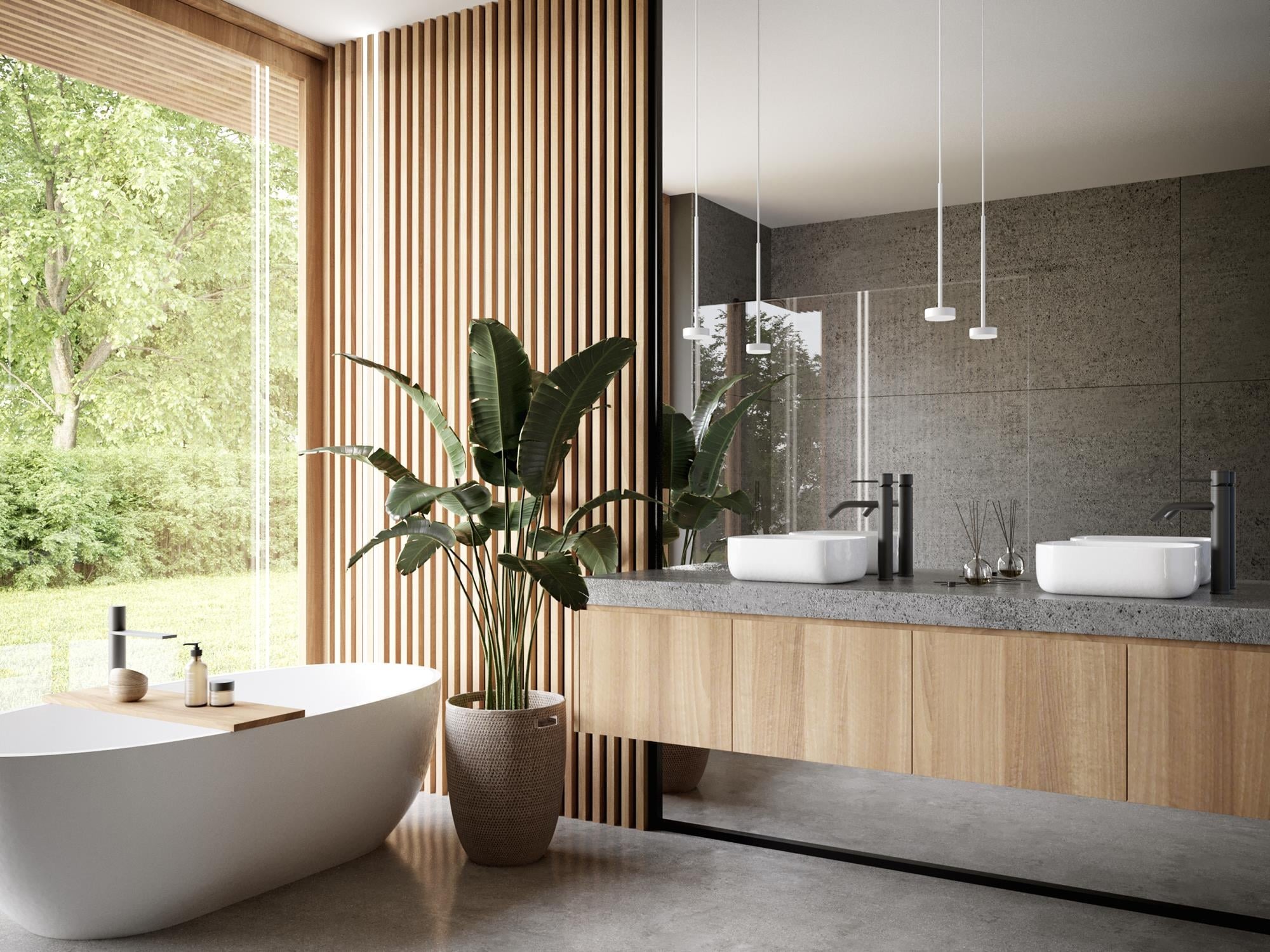Nowoczesna łazienka z wolnostojącą wanną, podwójną umywalką nablatową i drewnianymi akcentami, doświetlona naturalnym światłem wpadającym przez duże okno z widokiem na zieleń.