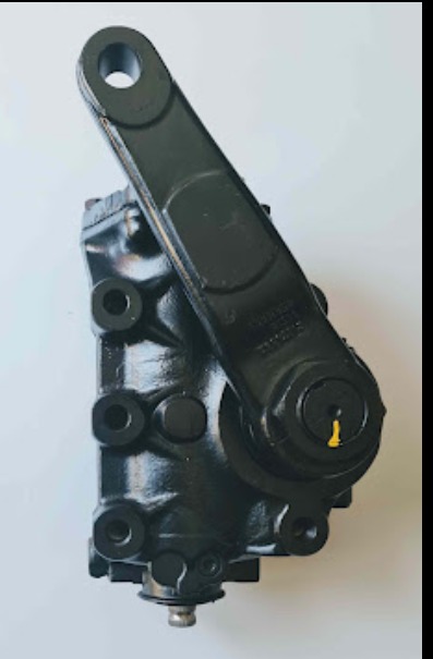 Czarna, metalowa przekładnia kierownicza z ramieniem, widoczne ślady montażu, oświetlenie studyjne.