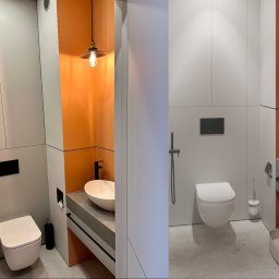 Miauart - Nowoczesna łazienka z pomarańczową ścianą akcentującą, wisząca toaleta i umywalka nablatowa z czarną armaturą, oświetlenie punktowe z żarówką Edisona.