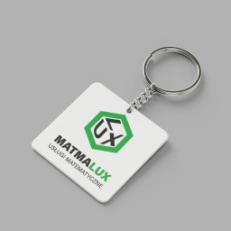 Joanna Stawowy - Biały, kwadratowy brelok z logo 'MATMALUX Usługi Matematyczne' na szarym tle, widoczne metalowe kółko i łańcuszek.