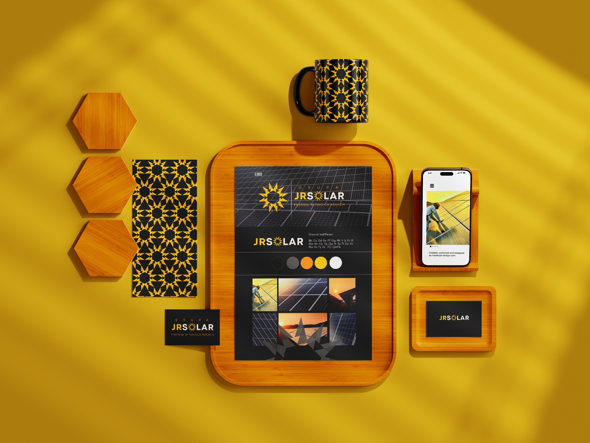 Prezentacja identyfikacji wizualnej JRSolar na żółtym tle: logo na wizytówce, kubku, tablecie z paletą barw i zdjęciami paneli słonecznych oraz smartfonie z mobilną wersją strony. Elementy ułożone...