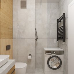 Zulo Design - Wizualizacja łazienki z pralką pod blatem, drewnianą zabudową umywalki, szarą płytką i czarnym grzejnikiem drabinkowym.