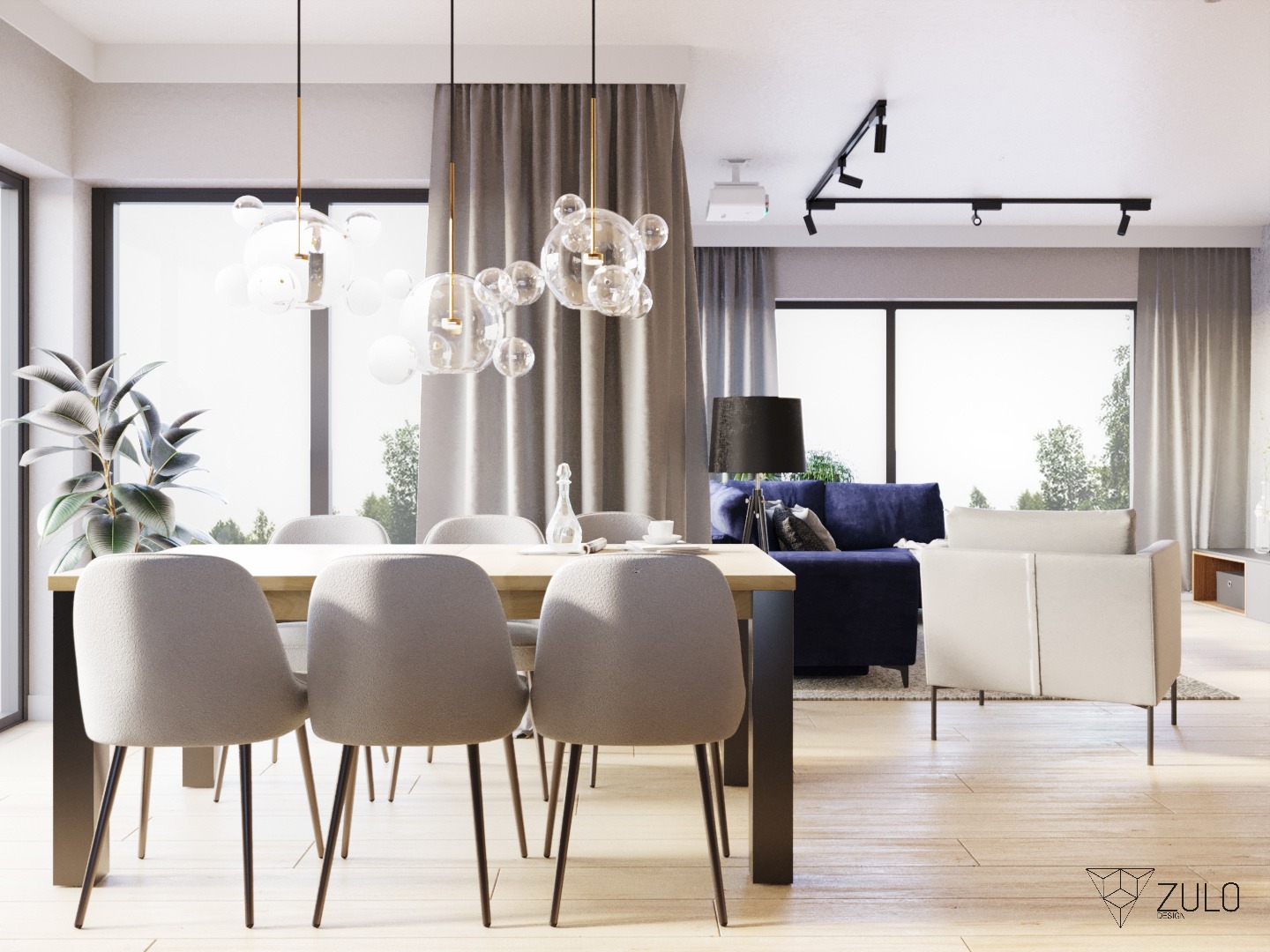 Jasne wnętrze z drewnianą podłogą, stołem z szarymi krzesłami, szklanymi lampami wiszącymi, niebieską sofą i białym fotelem w tle, oświetlenie szynowe na suficie i projektor.