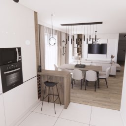 PROSVERO SPÓŁKA Z OGRANICZONĄ ODPOWIEDZIALNOŚCIĄ - Jasne, nowoczesne wnętrze z otwartą kuchnią, jadalnią i salonem. Białe meble kuchenne, drewniany stół z krzesłami, designerska lampa i minimalistyczny wystrój.