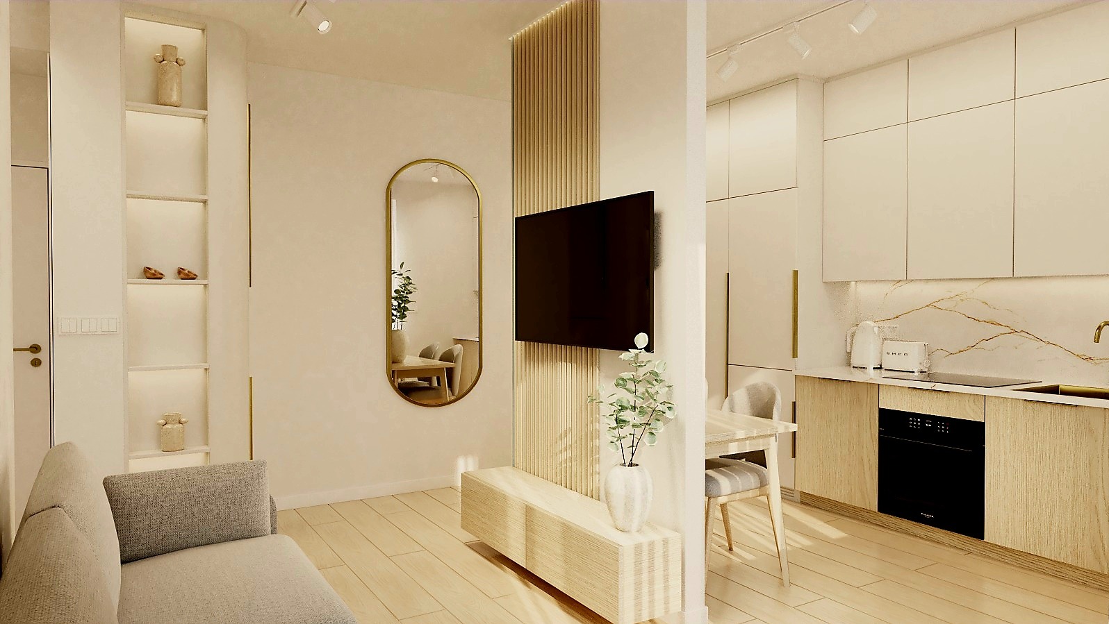 Nowoczesne wnętrze mieszkania z szarą sofą, owalnym lustrem w złotej ramie i telewizorem na drewnianej ściance działowej. Widoczna kuchnia z marmurowym blatem.