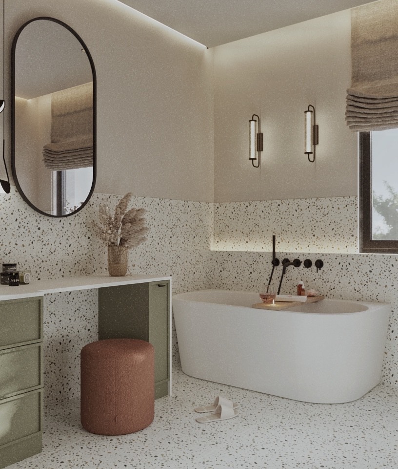 Nowoczesna łazienka w neutralnych barwach z wanną, toaletką z lustrem i okrągłym pufem. Ściany i podłoga wykończone w stylu lastryko.