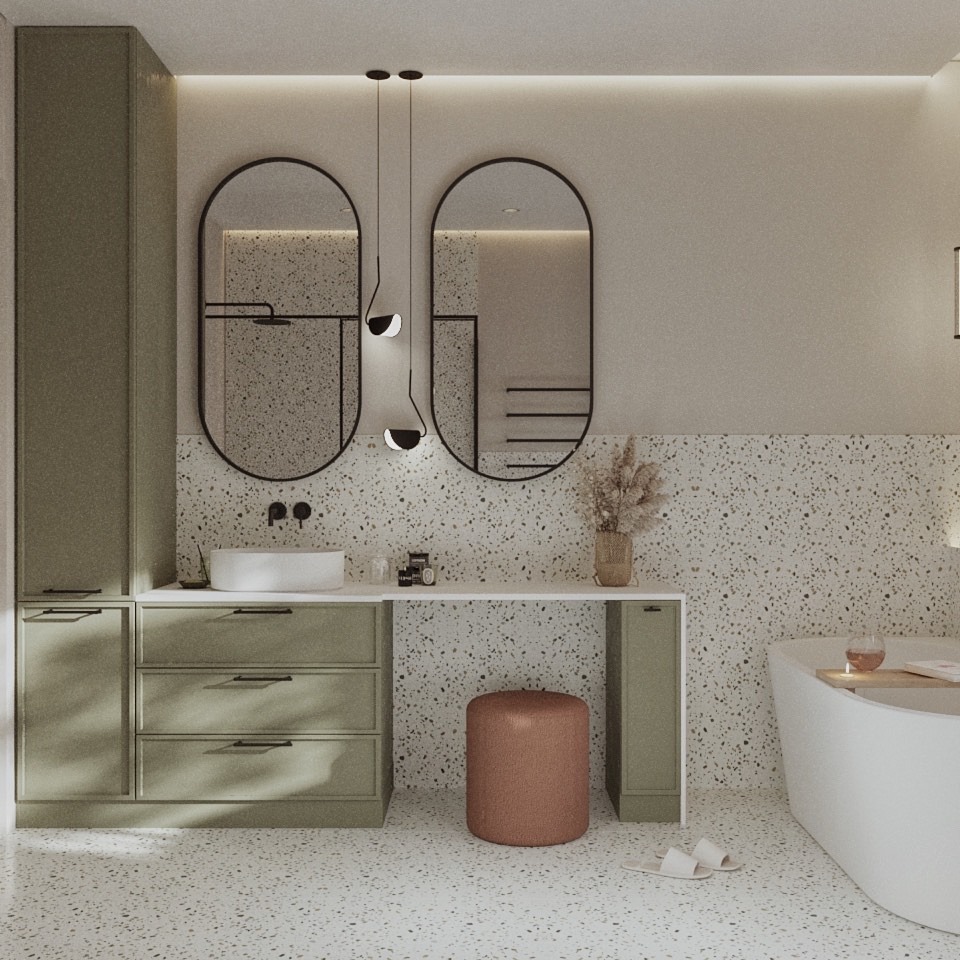 Nowoczesna łazienka z szafkami w odcieniach zieleni, okrągłymi lustrami i mozaiką. Uwagę przykuwają minimalistyczne lampy i dekoracyjny stołek.