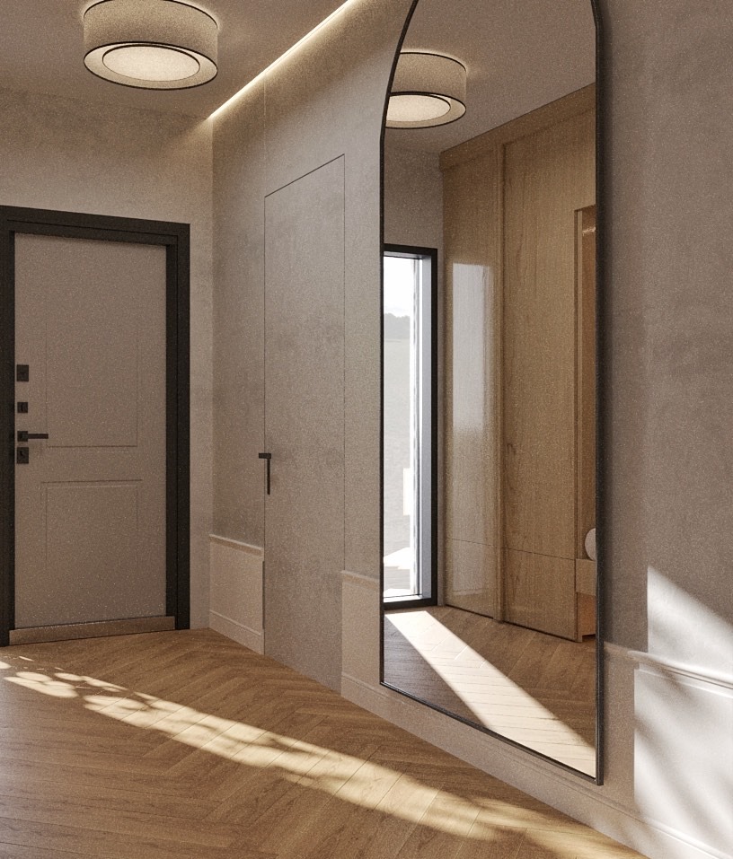 Nowoczesny przedpokój z lustrem w czarnej ramie, drewnianą podłogą w jodełkę i minimalistycznym oświetleniem sufitowym. Widoczne drzwi wejściowe i szafa wnękowa.