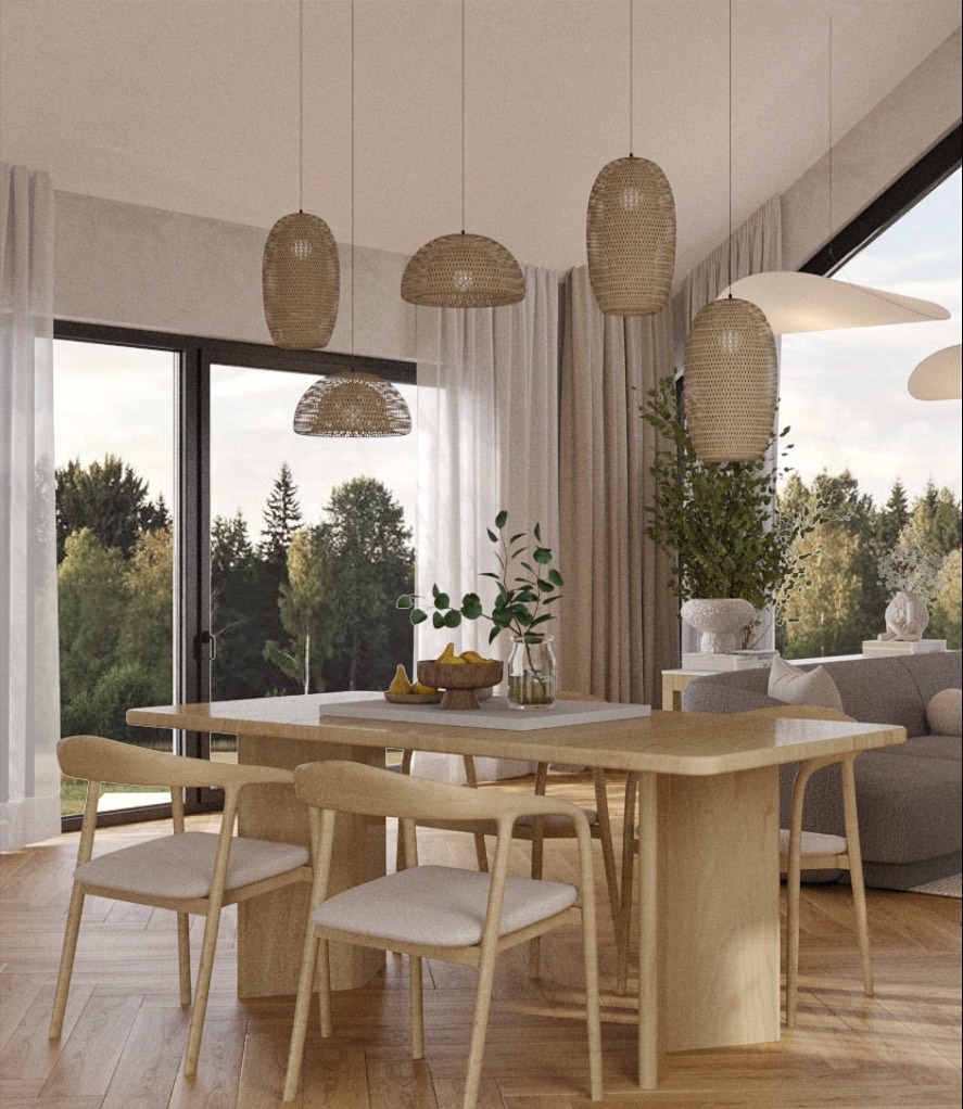 Jasna jadalnia z drewnianym stołem, krzesłami i lampami z wikliny. Za oknem widok na zieleń. Minimalistyczny styl, naturalne materiały, ciepłe oświetlenie.