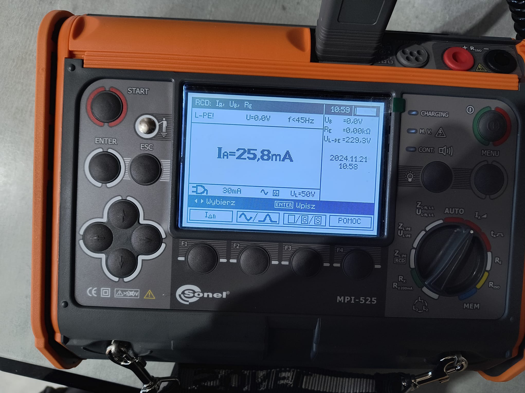 Miernik Sonel MPI-525 z ekranem wskazującym pomiar prądu upływu (Ia=25,8mA). Urządzenie w pomarańczowo-szarej obudowie z przyciskami i pokrętłem wyboru funkcji.