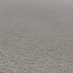 Renova Lublin - Jasna ściana z fakturą baranka, widoczna z dołu, z fragmentem ciemniejszego elementu konstrukcyjnego u góry.