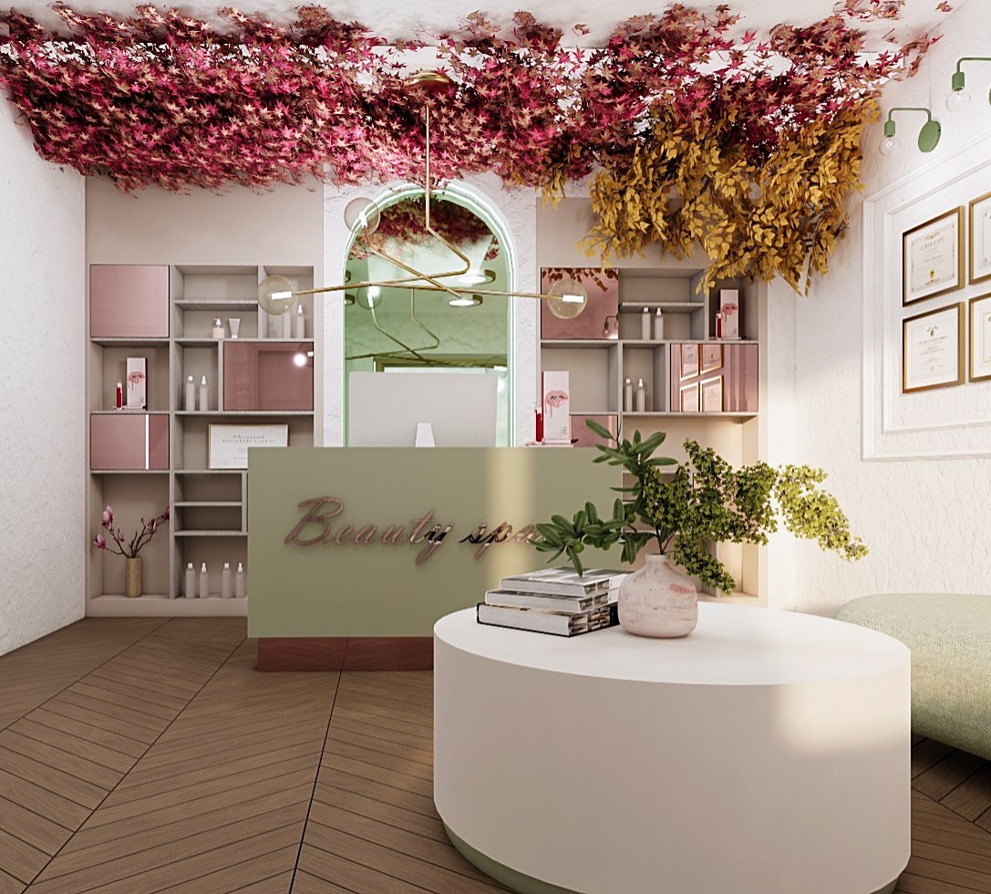 Recepcja w salonie beauty spa z dekoracją sufitową z liści, okrągłym stolikiem z książkami i rośliną w ceramicznym wazonie oraz półkami z kosmetykami w tle.