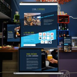 Stronit.pl - Projektowanie Stron Internetowych - Kompozycja graficzna prezentująca bar z grami wideo, z widocznymi ekranami laptopa i smartfona wyświetlającymi stronę internetową lokalu oraz fragment wnętrza z konsolami i graczami.