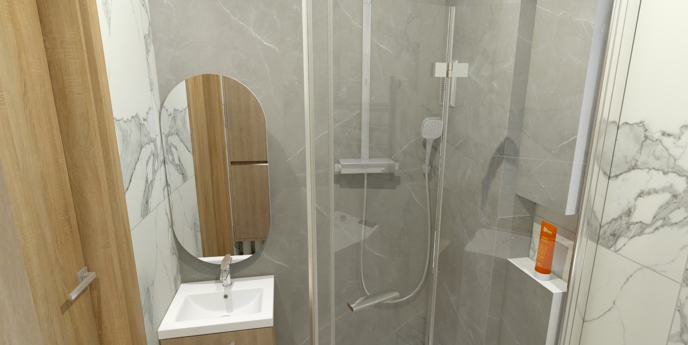 Nowoczesna łazienka z kabiną prysznicową, umywalką z szafką i owalnym lustrem. Ściany wyłożone płytkami imitującymi marmur. Widoczny dozownik na półce w kabinie.