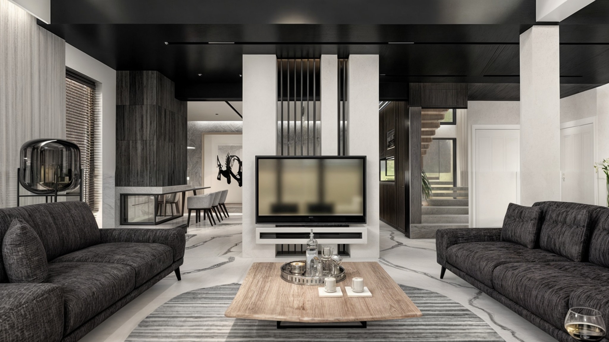 Nowoczesny salon z marmurową podłogą i drewnianym stolikiem kawowym, szare sofy i telewizor na białej ścianie działowej z metalowymi elementami dekoracyjnymi.