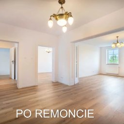 LIKIO - Przestronne wnętrze po remoncie z drewnianą podłogą, białymi ścianami i ozdobnymi lampami wiszącymi, widok na kilka pomieszczeń przez otwarte przejścia.