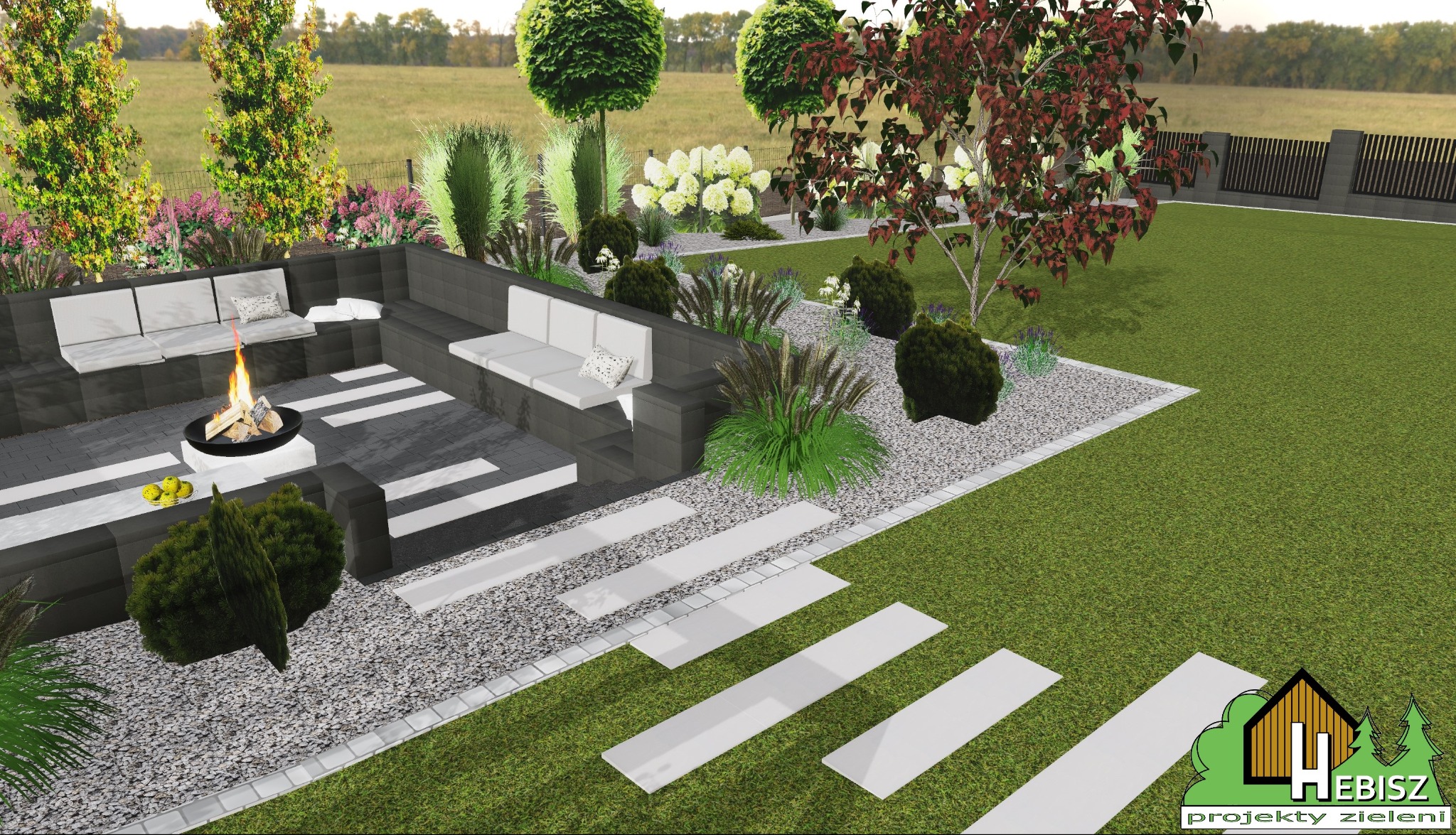 Wizualizacja realistyczna ogrodu z paleniskiem otoczonym siedziskami z szarych bloków, białymi poduszkami i dekoracyjnym oświetleniem, ścieżka z białych płyt na trawniku, drzewa ozdobne w tle.