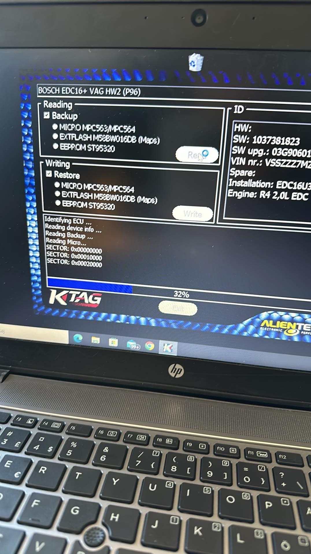 Laptop screen showing ECU tuning software KTAG during a backup process, displaying ECU identification and sector reading progress at 32%.