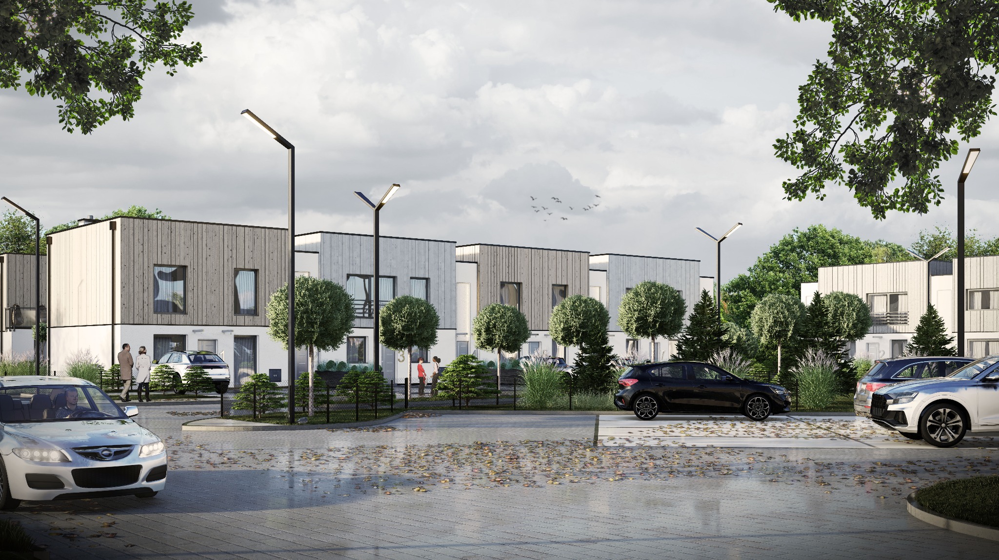 Wizualizacja osiedla domów jednorodzinnych z drewnianą elewacją, widok z poziomu ulicy, samochody zaparkowane na podjeździe, jesienne liście na kostce brukowej, nowoczesne lampy oświetleniowe.