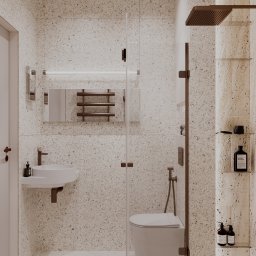 Archiidea Piotr Sekulski - Nowoczesna łazienka z kabiną prysznicową typu walk-in, umywalką na blacie i toaletą podwieszaną. Beżowe płytki imitujące lastryko na ścianach i podłodze.