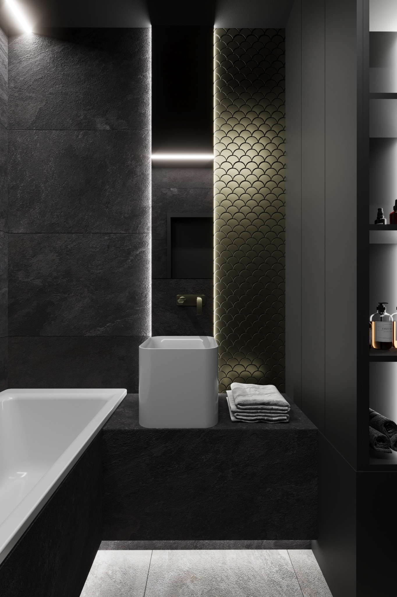 Nowoczesna łazienka w ciemnej tonacji: czarne płytki imitujące kamień, biała umywalka i wanna, złote akcenty na ścianie, minimalistyczne oświetlenie.