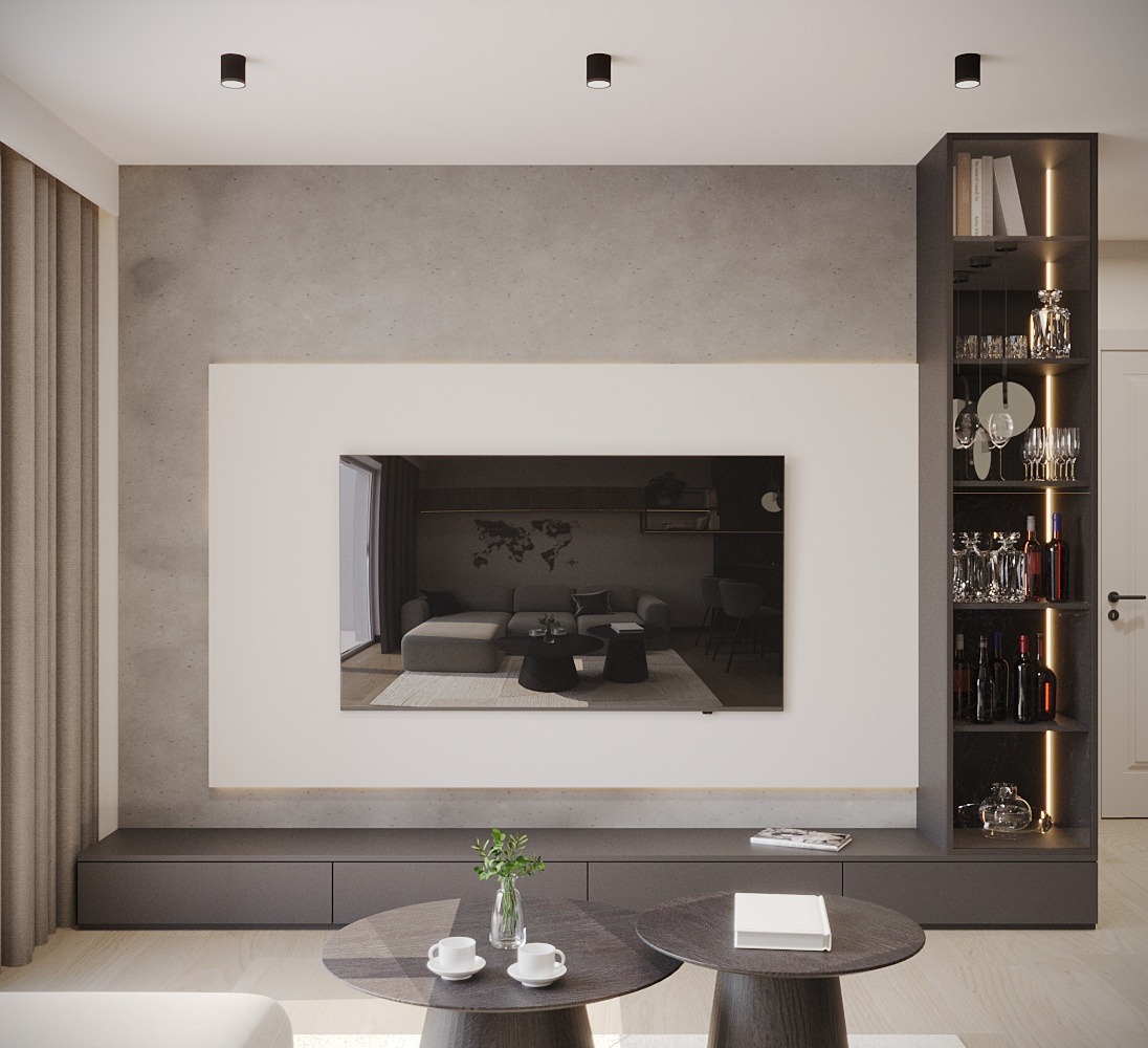 Nowoczesny salon z betonową ścianą, wbudowanym telewizorem wyświetlającym wnętrze innego salonu, podświetlaną półką z alkoholem i szklankami, oraz dwoma okrągłymi stolikami kawowymi z dekoracjami.