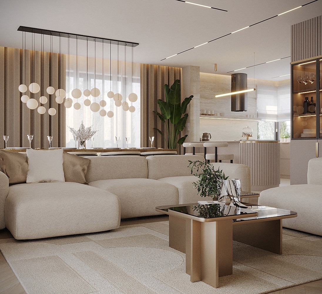 Jasne, przestronne wnętrze salonu z aneksem kuchennym, beżowa sofa modułowa, stolik kawowy z ciemnym blatem i rośliną, wisząca lampa z kulistymi kloszami, stół z nakryciem i krzesłami w tle...
