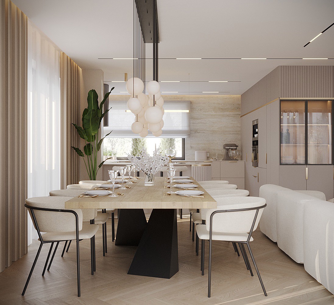 Elegancka jadalnia z drewnianym stołem na czarnej podstawie, krzesła z jasną tapicerką i nowoczesna lampa wisząca z białych kul, widok na kuchnię w tle.