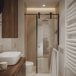 Moye Concept - Nowoczesna łazienka z drewnianą szafką pod umywalką, kabiną prysznicową ze szklanymi drzwiami przesuwnymi na czarnych szynach oraz białym grzejnikiem drabinkowym i wiszącym ręcznikiem.