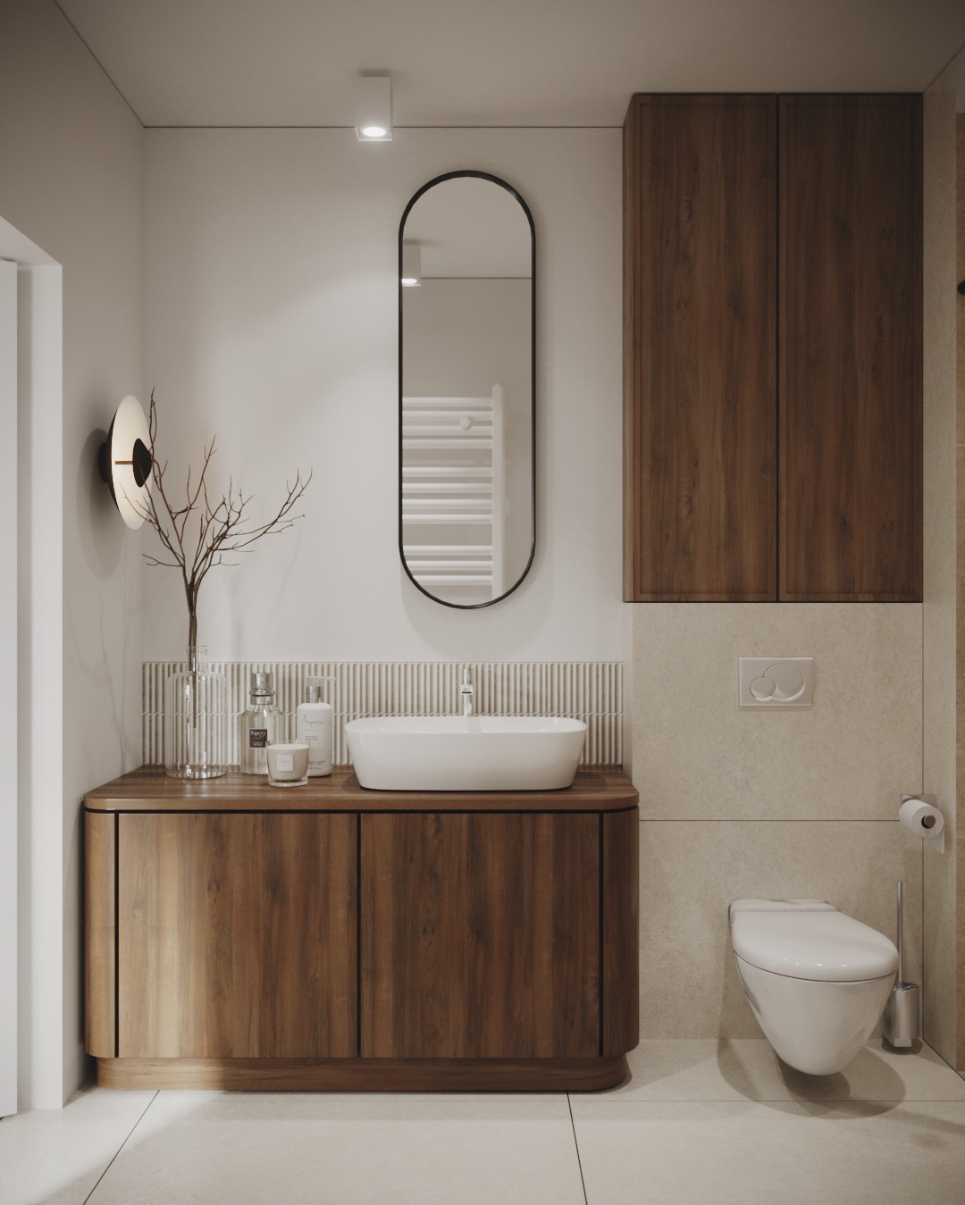 Nowoczesna łazienka z drewnianą szafką pod umywalką nablatową, owalnym lustrem w czarnej ramie i minimalistyczną toaletą podwieszaną.