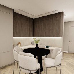 DDESIGN - Wizualizacja nowoczesnej kuchni z ciemnymi szafkami górnymi, jasnym blatem i okrągłym, czarnym stołem otoczonym białymi krzesłami. W tle widoczny minimalistyczny salon z beżową sofą i abstrakcyjnym...