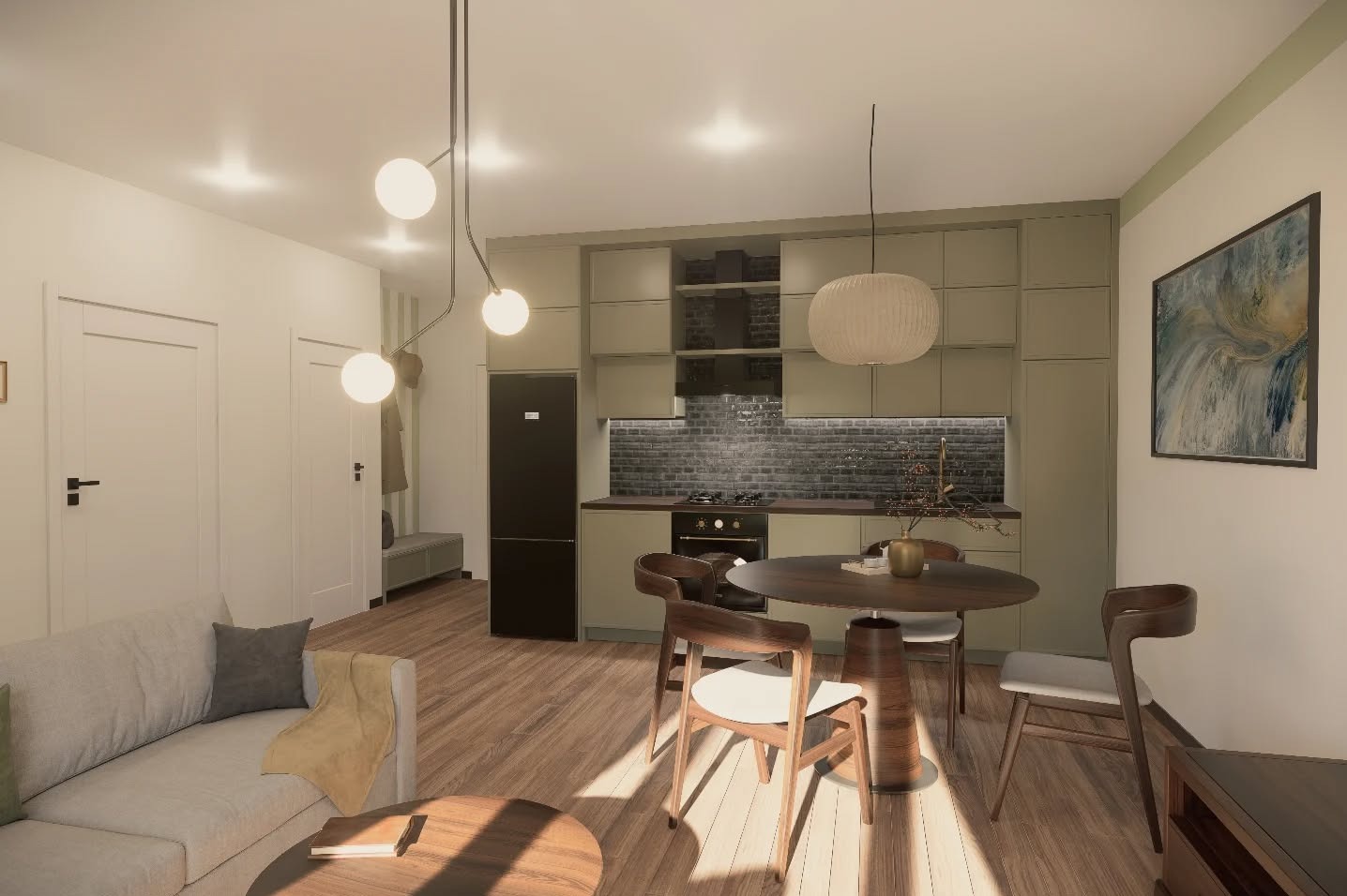 Wnętrze mieszkania: salon z aneksem kuchennym. Drewniany stół z krzesłami, szara sofa i okrągły stolik kawowy. Kuchnia w odcieniach zieleni z czarnym blatem i ceglaną ścianą.