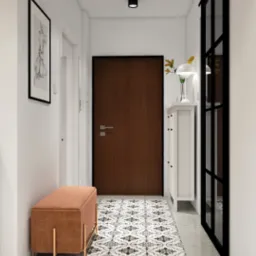 Nowoczesny przedpokój z brązowymi drzwiami, wzorzystą posadzką i pomarańczową pufą. Minimalistyczny wystrój z czarnymi akcentami i białymi ścianami.