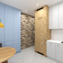 KATARZYNA BENKO OCH-ACH_CONCEPT - Nowoczesna kuchnia z niebieskimi szafkami, drewnianym stołem i lampą w pastelowych kolorach, uzupełniona ścianą z cegły i białymi szafkami z mozaiką.