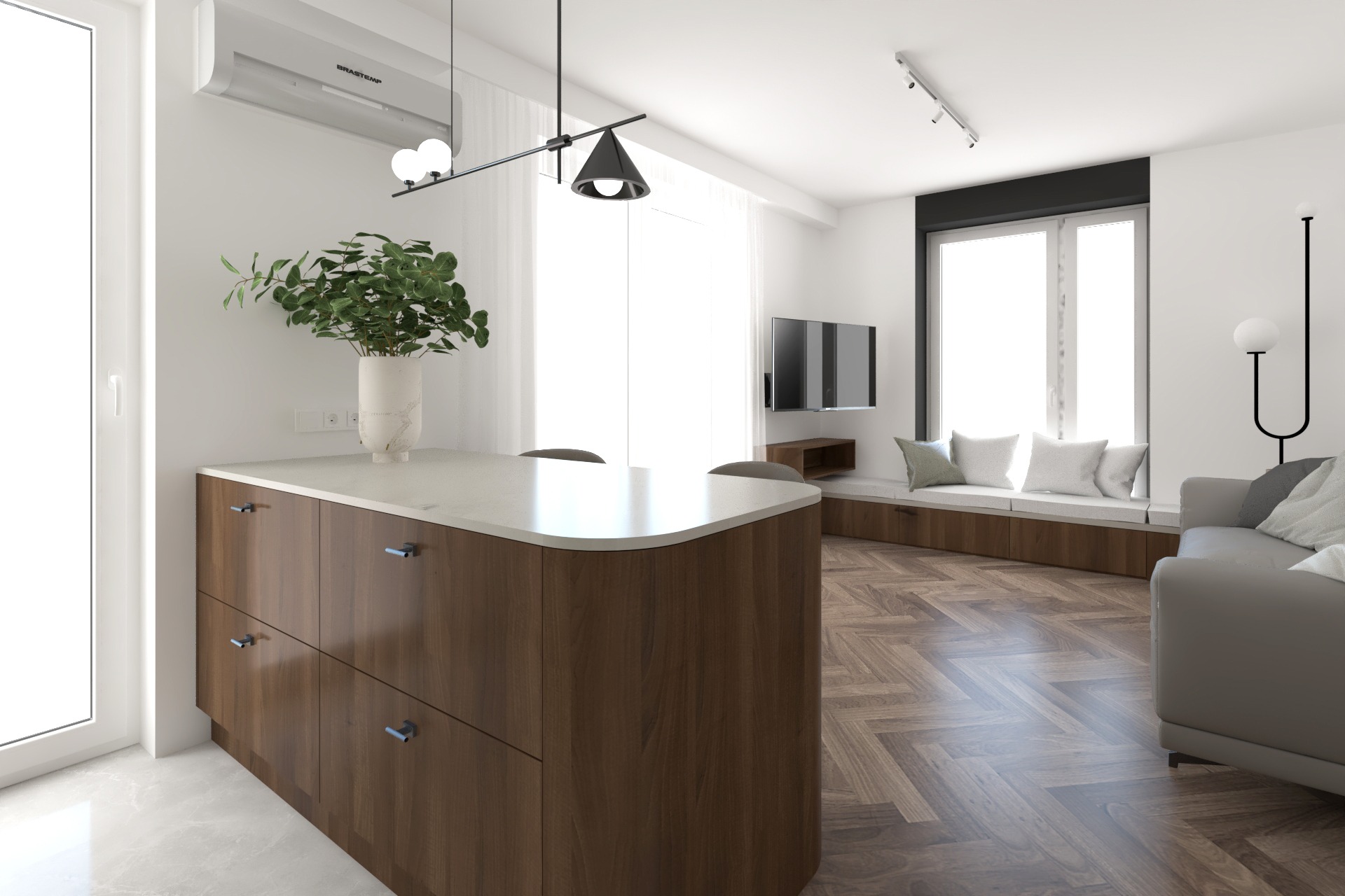 Nowoczesna kuchnia z wyspą i drewnianymi szafkami, jasnym blatem, rośliną w wazonie, oświetleniem punktowym i parkietem w jodełkę, widok na salon z oknem i siedziskiem.