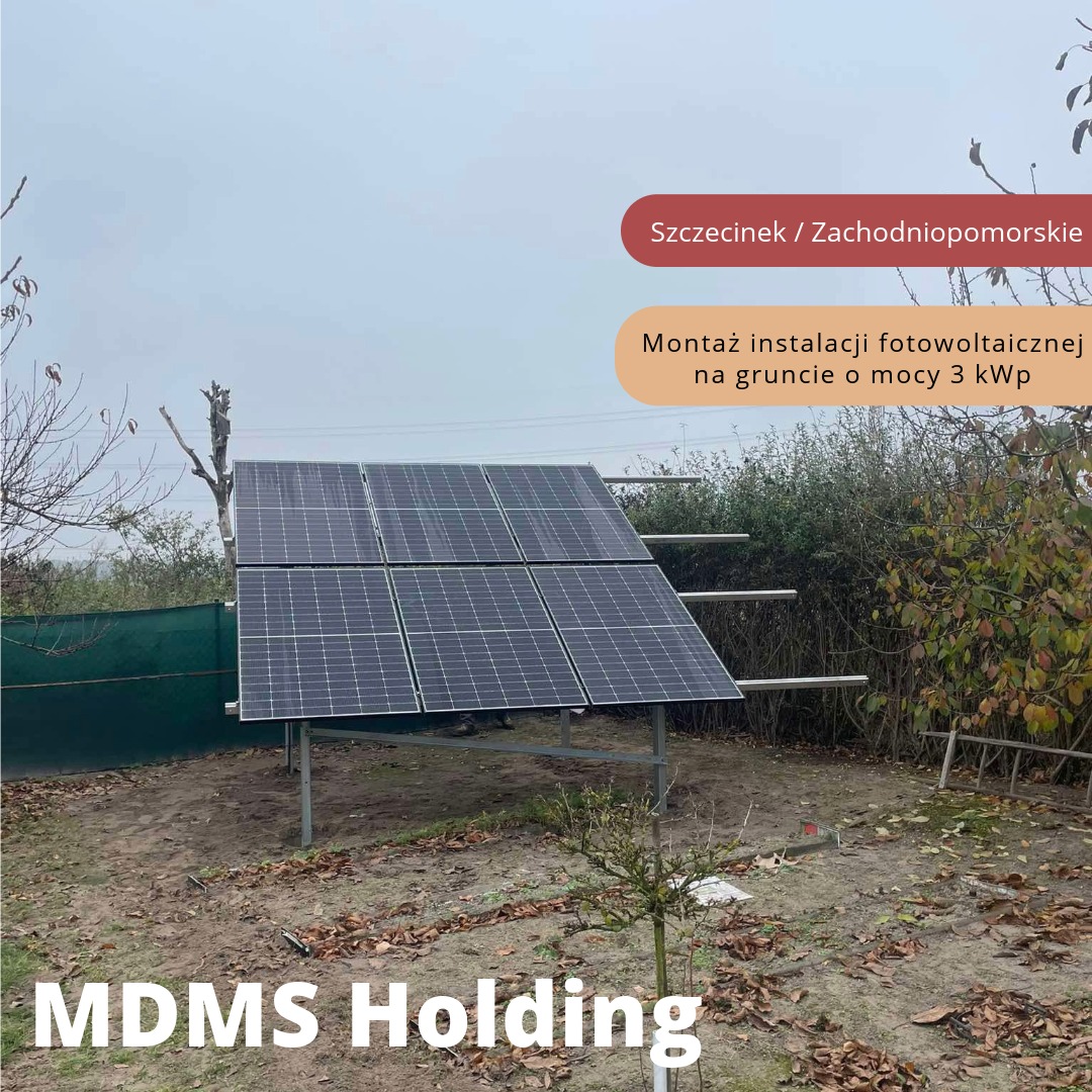 Instalacja solarna na gruncie, z panelami ustawionymi pod kątem, widoczna drabina oparta o ogrodzenie i niewielkie drzewko na pierwszym planie.