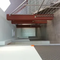 Wewnętrzne schody z poręczami ze stali nierdzewnej, widok z góry, z elementami ceglanymi i minimalistycznym wykończeniem ścian.