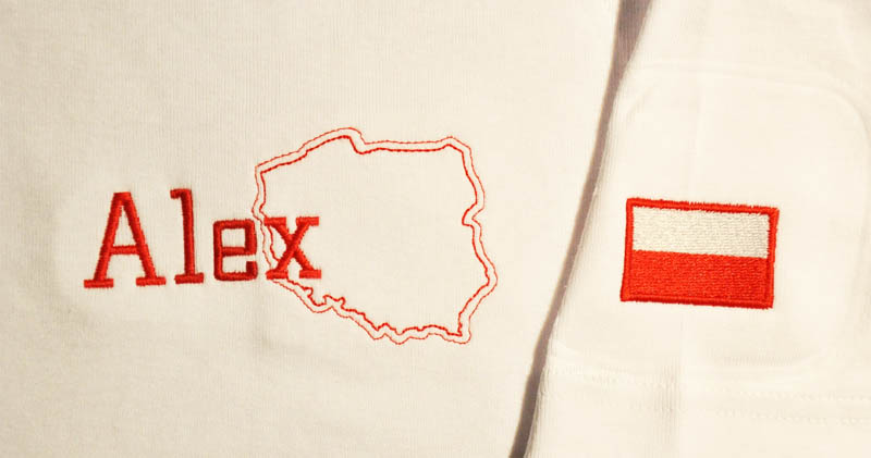 Biała bluza z czerwonym haftem: imię 'Alex', kontur Polski i flaga Polski na rękawie.