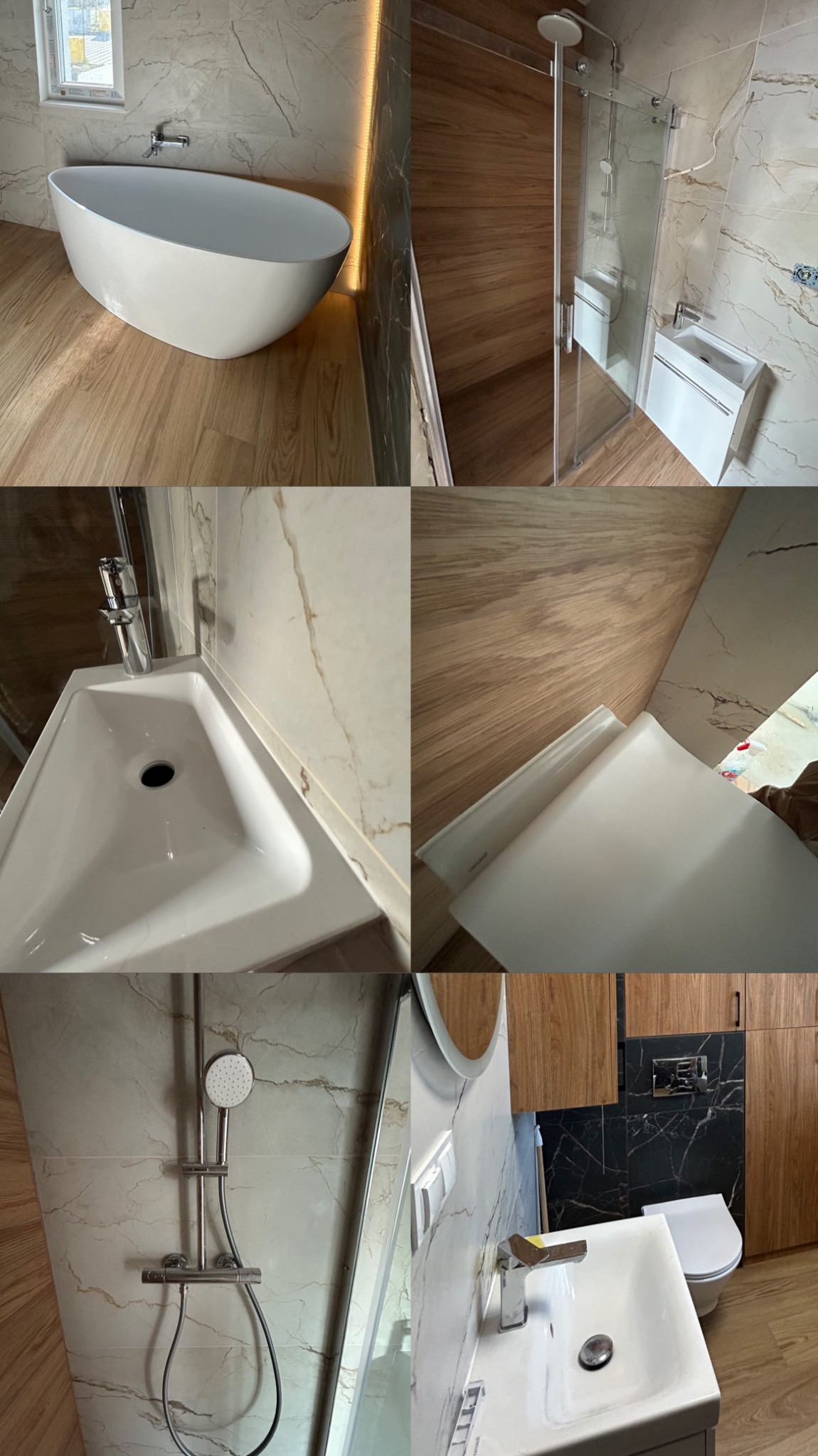 Wnętrze łazienki po remoncie, z wolnostojącą wanną, kabiną prysznicową ze szklanymi drzwiami przesuwnymi, umywalką nablatową i toaletą, wykończone płytkami imitującymi marmur i drewnem.