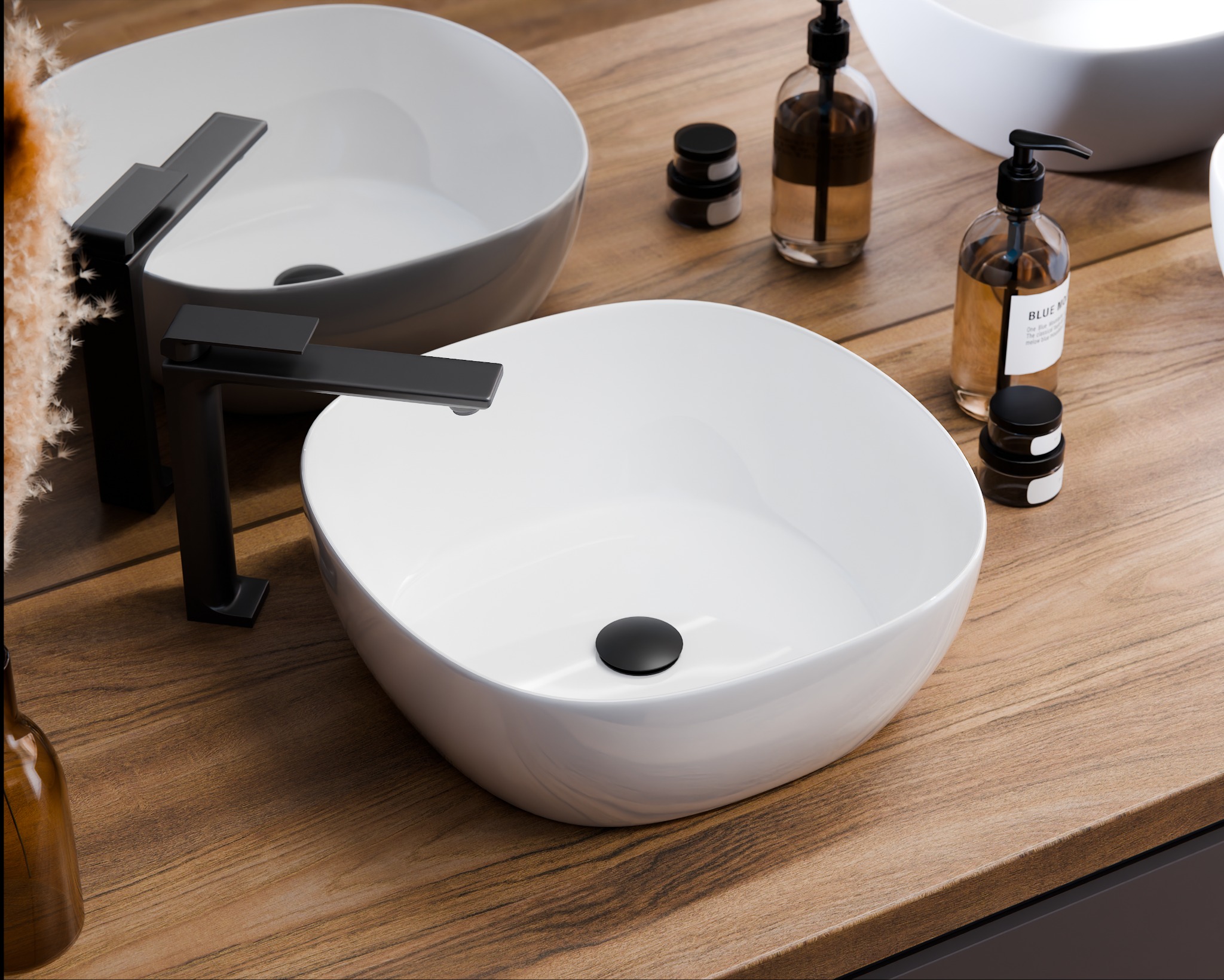 Umywalka nablatowa w kształcie łezki z czarną armaturą i akcesoriami łazienkowymi na blacie z drewna, ujęcie z bliska.