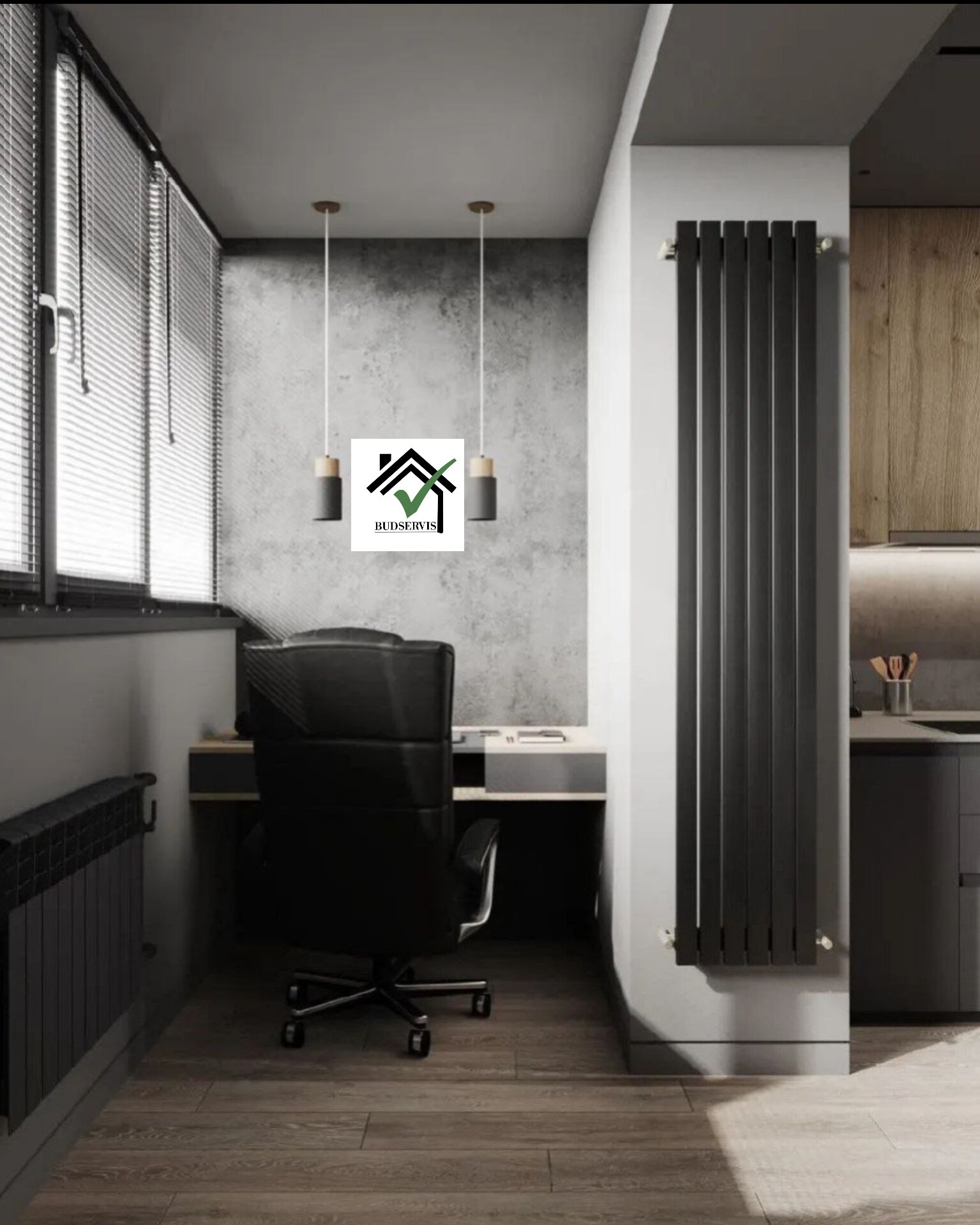 Szara ściana z dekoracyjnym grzejnikiem, biurko z krzesłem obrotowym i oświetleniem punktowym, widok na fragment kuchni z drewnianymi szafkami.