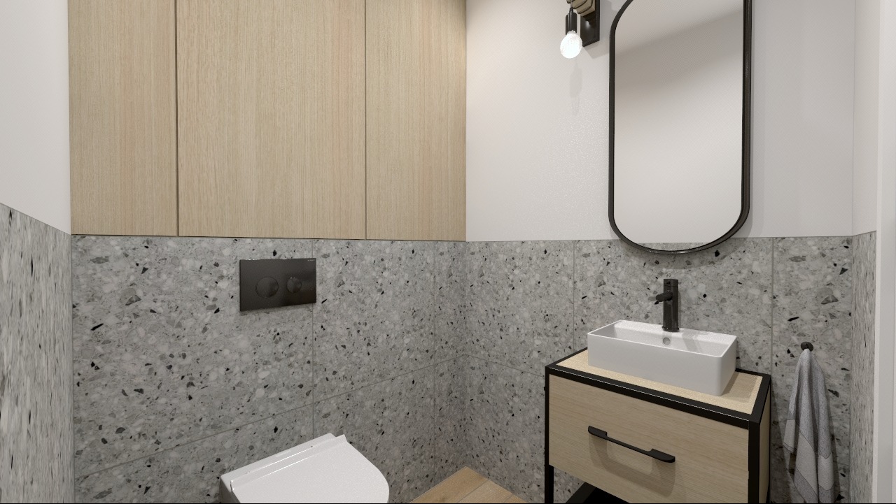 Nowoczesna łazienka z umywalką nablatową, szafką z drewnianym frontem i czarnymi detalami, lustro w czarnej ramie i płytki imitujące lastryko na ścianach.