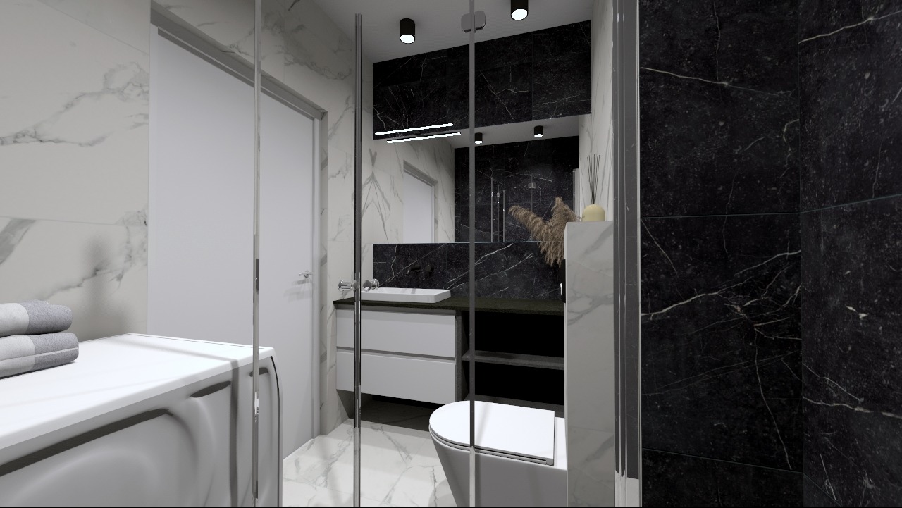 Nowoczesna łazienka z czarnymi marmurowymi płytkami, białą umywalką nablatową, szafką pod umywalką z szufladami oraz toaletą. Na blacie dekoracje z suszonych traw. Kabina prysznicowa...