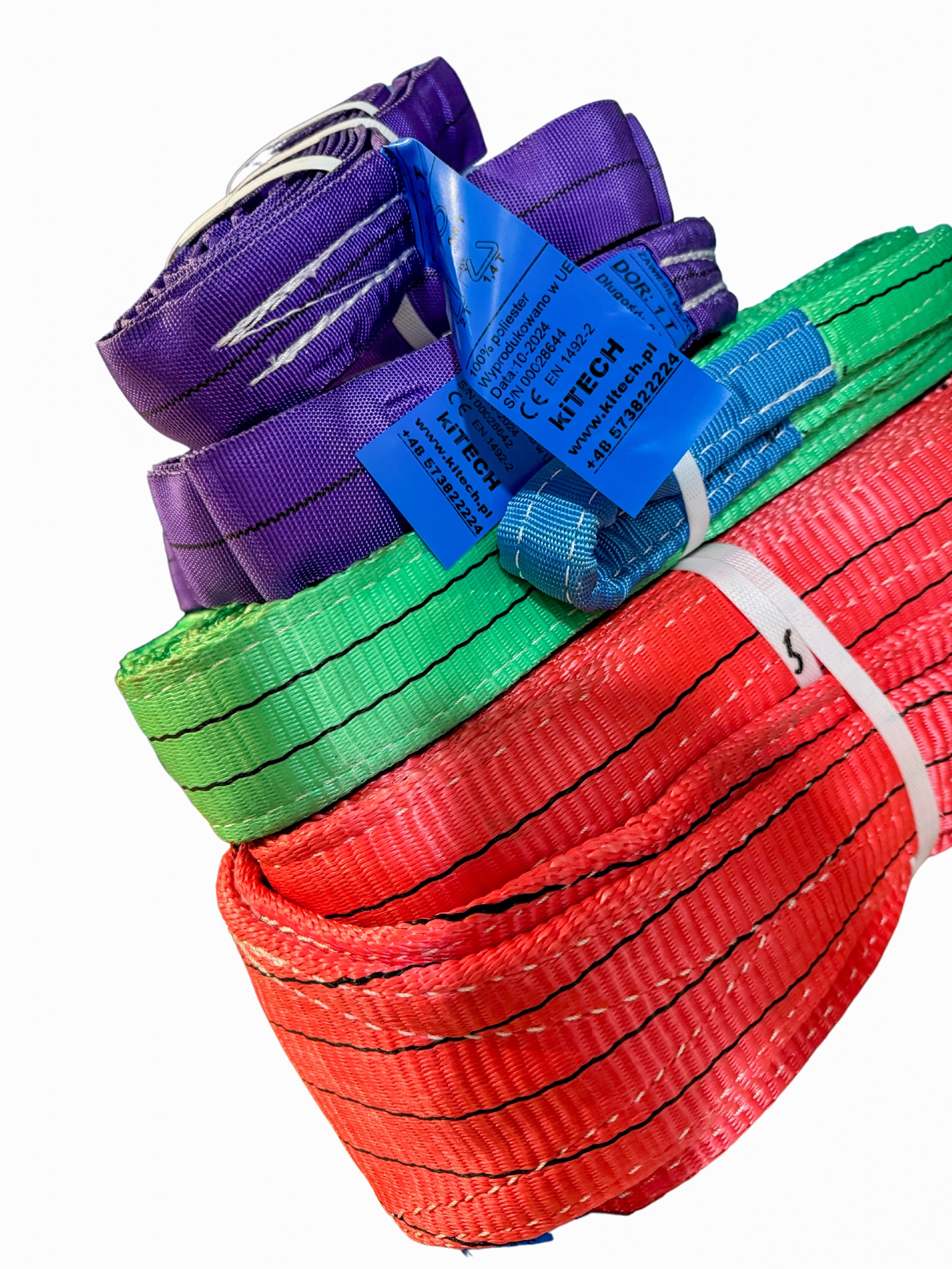Stos kolorowych pasów transportowych (fioletowy, zielony, czerwony) z etykietami producenta KITECH, zabezpieczonych białymi opaskami.